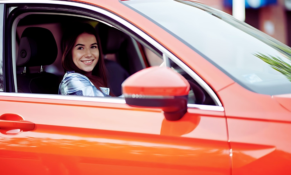 A woman drives a car delighted with her award winning car salary sacrifice scheme